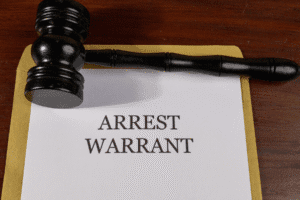 Arrest Warrant Document with Judge's Gavel – Arizona Criminal Defense