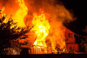 Burning house at night representing felony arson charges and prison time penalties in Arizona – Rideout Law Group