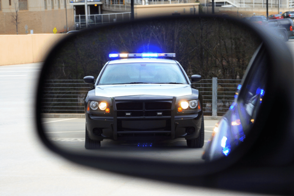 Police car with flashing lights pulling over driver for suspected DUI in Tempe, Arizona