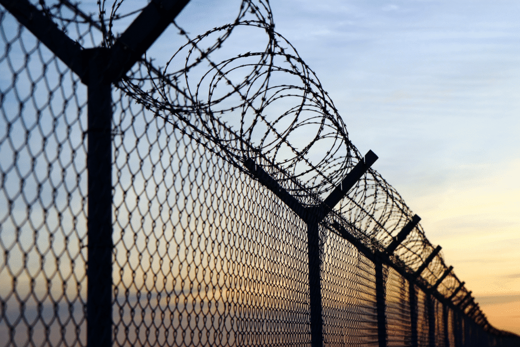 Arizona writ of habeas corpus representation with prison fence and barbed wire at sunset in Scottsdale