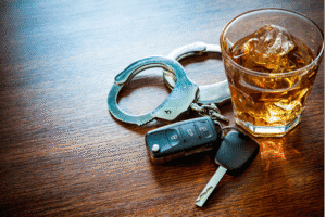 Scottsdale DUI lawyer explains Arizona drunk driving laws with keys, handcuffs, and whiskey glass