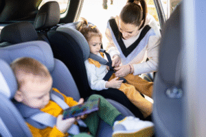 Mother buckling child into car seat – Arizona child passenger safety law