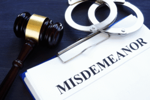 Gavel, handcuffs, and misdemeanor legal file representing common misdemeanor charges in Arizona