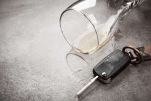 Empty wine glass and car key symbolizing DUI arrest in Scottsdale, Arizona