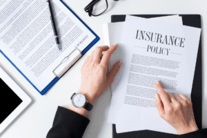 Hands reviewing an insurance policy document – Rideout Law Group, Arizona