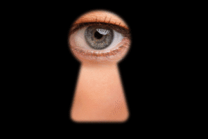 Voyeurism crime illustration – person looking through keyhole, Arizona criminal defense context