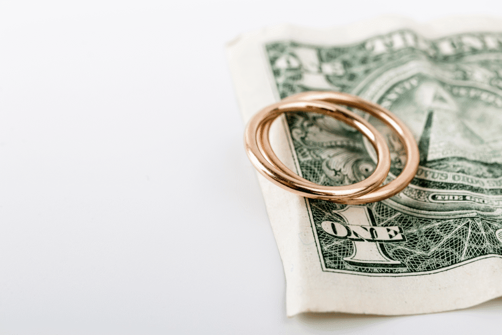 Wedding rings on dollar bill symbolizing cost of divorce in Arizona