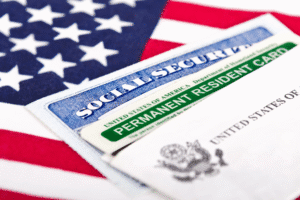 Social Security card and Permanent Resident Card on American flag background