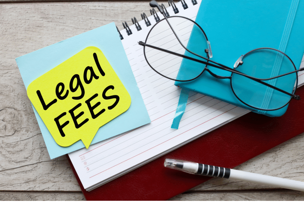 Legal fees note on desk beside glasses and journal – Rideout Law family law attorney Arizona