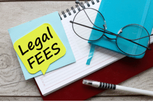 Legal fees note on desk beside glasses and journal – Rideout Law family law attorney Arizona