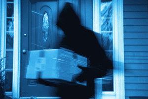 Hooded porch pirate stealing package from front door in Arizona