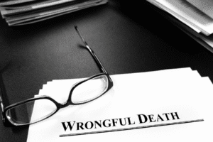 Documents labeled “Wrongful Death” on a desk with reading glasses, representing legal cases handled by Scottsdale wrongful death attorneys.
