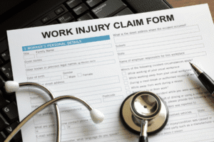 Work injury claim form on keyboard with stethoscope – Arizona workplace injury documentation