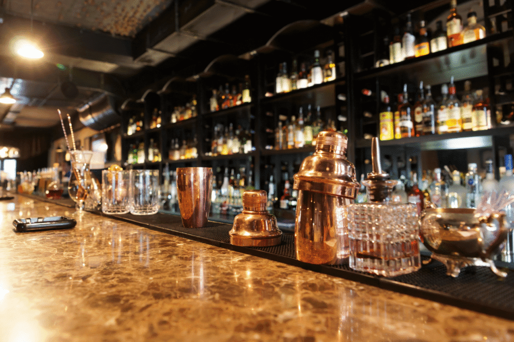 Bar counter with alcohol bottles and cocktail shakers – dram shop liability in Arizona