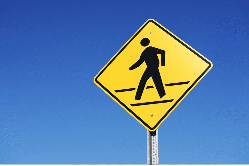 pedestrian sign Arizona, crosswalk safety, pedestrian right of way, Scottsdale pedestrian law, traffic safety sign, Arizona traffic laws, crosswalk rules, personal injury law, Rideout Law Group, pedestrian accident awareness