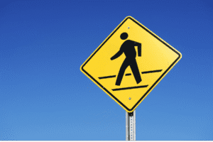 pedestrian sign Arizona, crosswalk safety, pedestrian right of way, Scottsdale pedestrian law, traffic safety sign, Arizona traffic laws, crosswalk rules, personal injury law, Rideout Law Group, pedestrian accident awareness