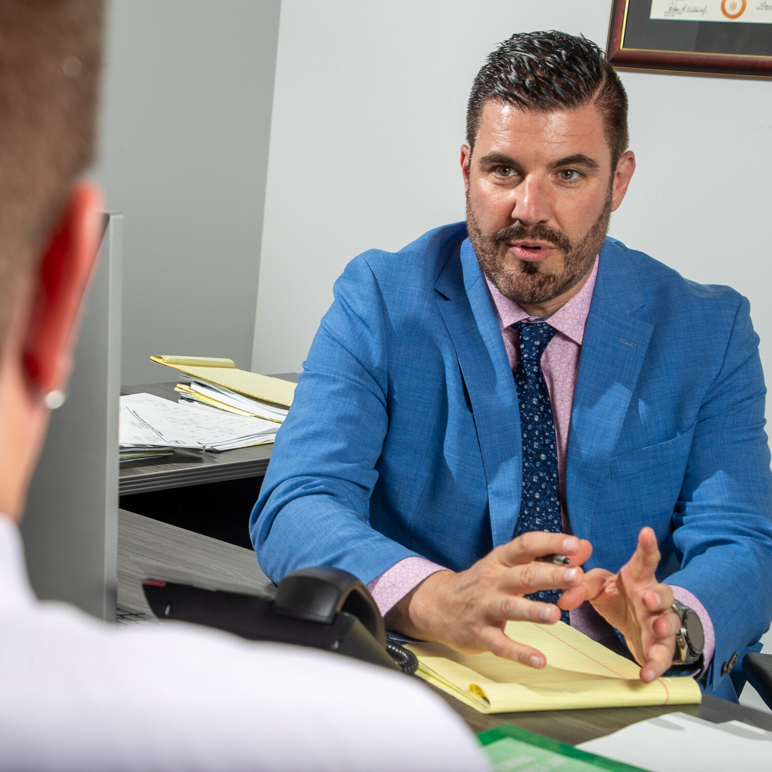 brad-rideout-scottsdale-trial-attorney-consultation Brad Rideout, managing attorney of Rideout Law Group in Scottsdale, meeting with a client about their case. Known for trial advocacy in criminal, family, and juvenile law.